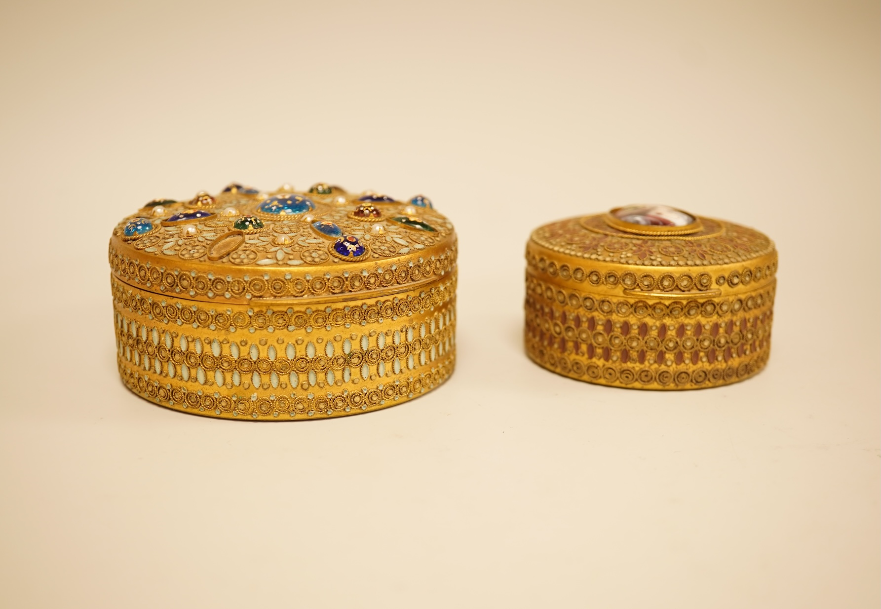 Two Limoges enamel mounted gilt filigree work circular boxes, largest 8cm diameter